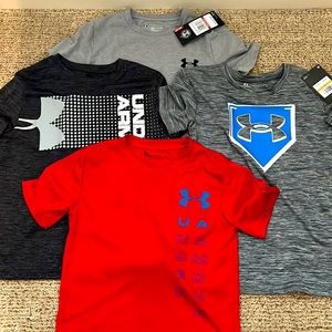 2 NWT and 2 like new Under Armour tees. Boys Size 7 and XS